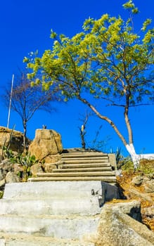 Beautiful rocks cliffs stones and boulders on mountain with natural stairs on the beach in Zicatela Puerto Escondido Oaxaca Mexico.