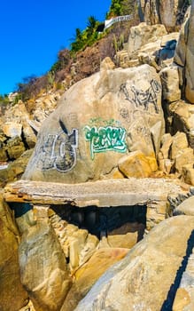 Beautiful rocks cliffs stones and boulders on mountain with natural stairs on the beach in Zicatela Puerto Escondido Oaxaca Mexico.