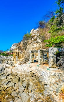 Beautiful rocks cliffs stones and boulders on mountain with natural stairs on the beach in Zicatela Puerto Escondido Oaxaca Mexico.