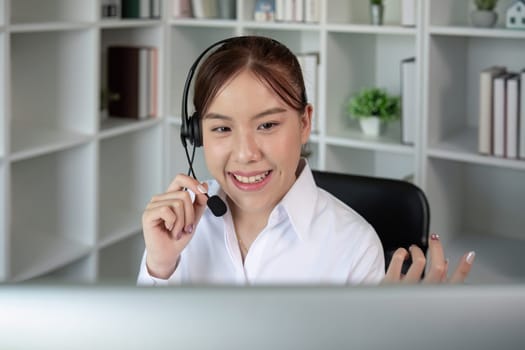 Call center agents wear headphones to talk to customers. Provide consultation via online channels on laptops.