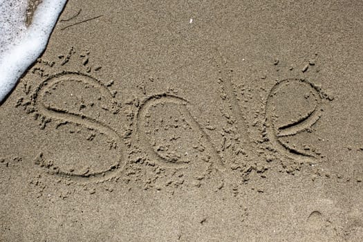 Sale. Word on the sand. Sea beach