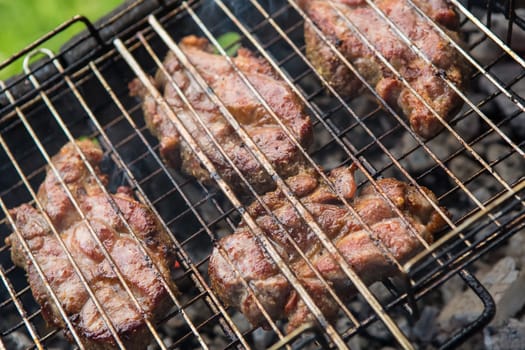 pieces meat char-grilled over flame. food background vegetables char-grilled over flame
