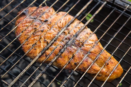 Fish background. Vegetables char-grilled over flame