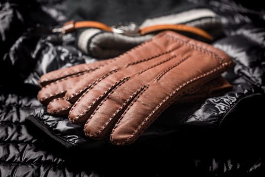 Pair of men's brown leather gloves and other men's accessories.