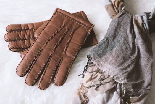 Pair of men's brown leather gloves and other men's accessories.