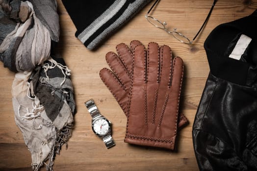 Pair of men's brown leather gloves and other men's accessories.