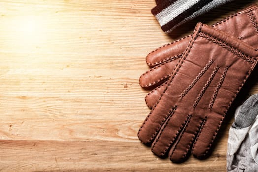 Pair of men's brown leather gloves and other men's accessories.