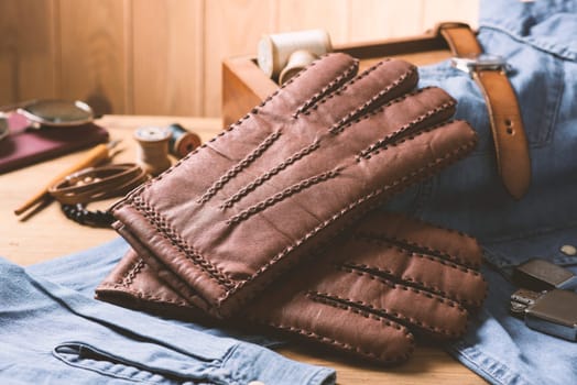 Pair of men's brown leather gloves and other men's accessories.