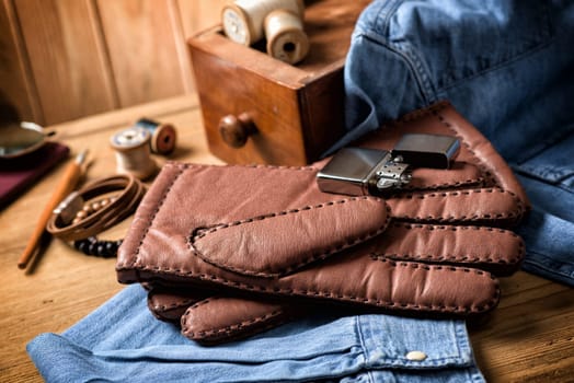 Pair of men's brown leather gloves and other men's accessories.