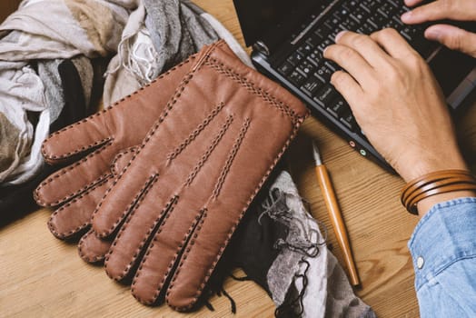 Pair of men's brown leather gloves and other men's accessories.