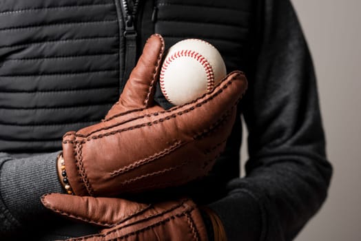 A man wearing the brown leather gloves in winter.