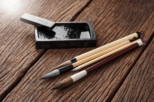 closeup traditional writing brush on wooden desk, Japanese writing brush, Chinese writing brush
