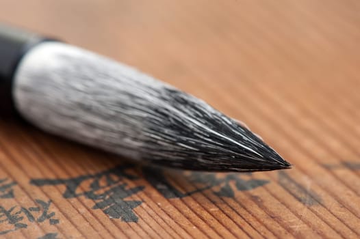 traditional writing brush isolated on wood background, Japanese writing brush, Chinese writing brush