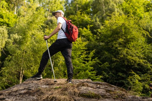 Man hiking in the mountains with a backpack.