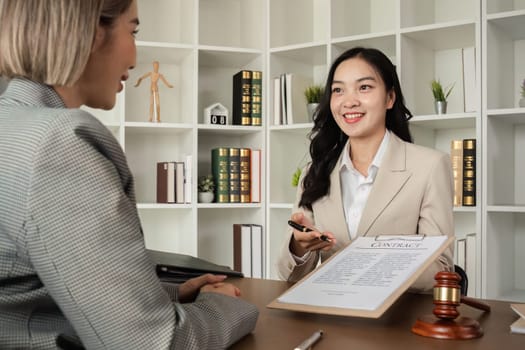 Lawyer and businesswomen discussing and introducing Providing legal advice regarding signing insurance contracts or financial contracts.