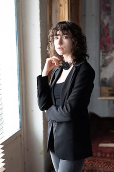 portrait of a young beautiful woman with curly hair in the studio