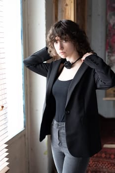 portrait of a young beautiful woman with curly hair in the studio