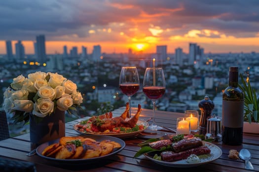 A table with a variety of food and drinks, including wine glasses and a bottle of wine. The table is set for a romantic dinner, with candles and flowers as decorations