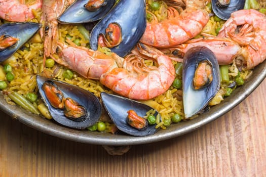 Freshly cooked seafood paella with vibrant colors served in a rustic pan, typical Spanish cuisine, Majorca, Balearic Islands, Spain,