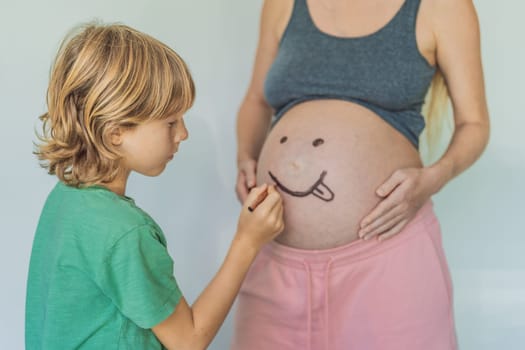 Adorable moment as a son adds a touch of joy to his mother's pregnancy, playfully drawing a funny face on her baby bump, creating cherished memories.