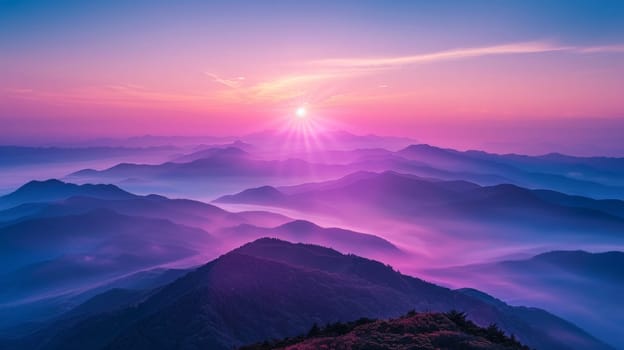 A mountain range with a sun setting behind it
