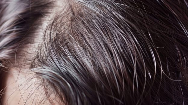 A close up of a woman's hair with some gray in it