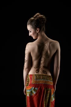 Mehendi. On woman's back henna pattern dreamcatcher. Studio photo