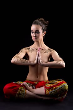 Mehendi. Beautiful woman meditating in lotus position