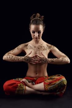 Yoga. Woman's body covered with beautiful floral patterns