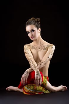 Image of topless brunette with mehendi on chest and shoulders