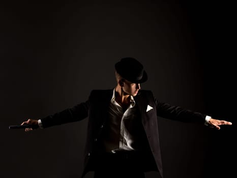 Studio photo of male dancer dressed as gangster