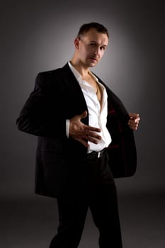 Strip dance. Image of attractive man in suit with stripes