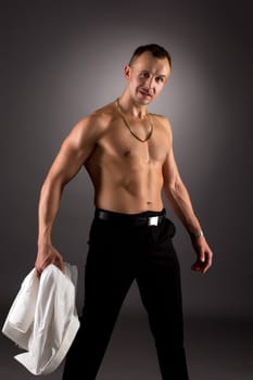 Male dancer took off his shirt and posing at camera