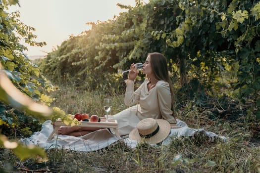 Picnic and wine tasting at sunset in the hills of Italy, Tuscany. Vineyards and open nature in the summer. Romantic dinner, fruit and wine.