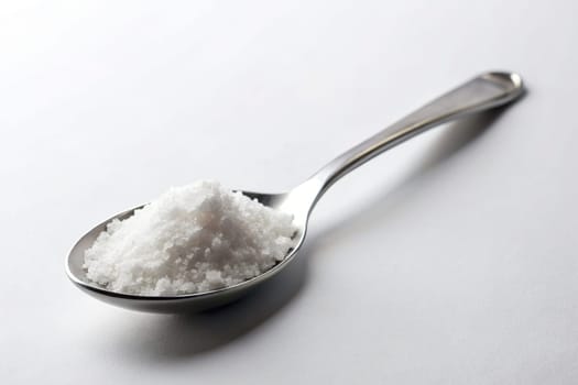 Close up of a spoon full of salt on background. isolated. Food concept.