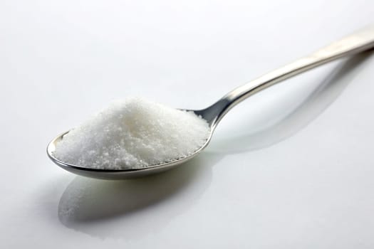 Sugar in a spoon on background, close-up. isolated. Food concept.