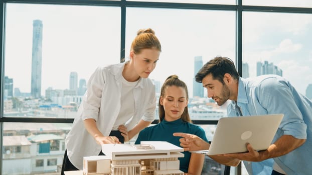 Smart architect team discussion about house design while handsome male worker present idea by using laptop. Group of professional engineer sharing, brainstorming design. Business design. Tracery