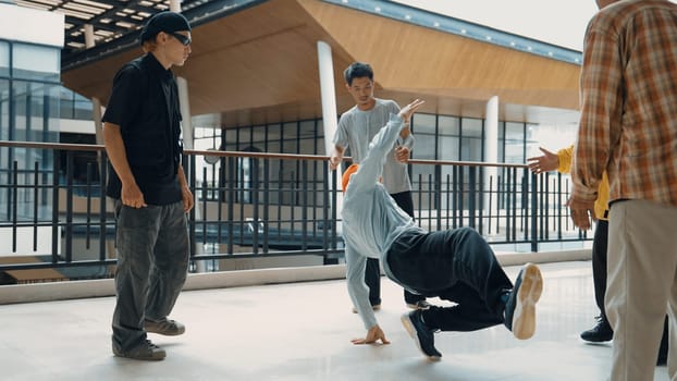 Hip hop team dance break dance while multicultural friend surrounded and clapping hands to cheer or encourage his friend to dance. Active and energetic street dance. Outdoor sport 2024. Endeavor.