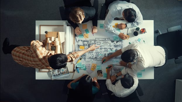 Top aerial view of project manager or civil engineer writing at blueprint and planning building design. Aerial view of architect working together at meeting table with document placed. Alimentation.