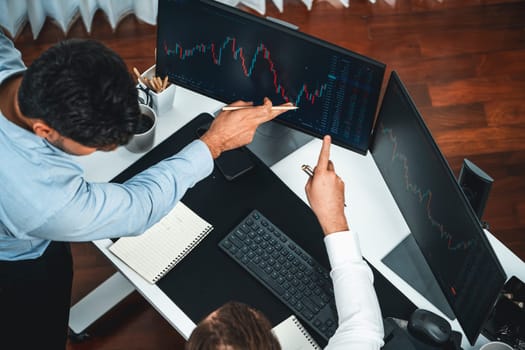 Business professional brokers discussing stock market on pc screen in real time, analyzing dynamic exchange rate database graph or interesting unit investment for trading in valued growth. Sellable.