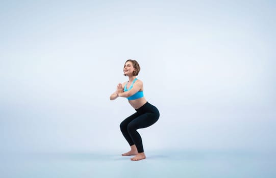 Full body length gaiety shot athletic and sporty woman doing healthy and meditative yoga exercise workout posture on isolated background. Healthy active and body care lifestyle