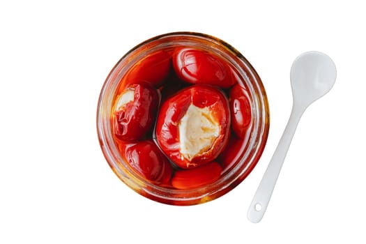 Stuffed cherry peppers with ricotta cheese filling in glass jar on white background