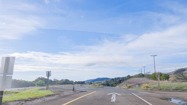 Driving on HWY 101 near Santa Barbara, California, the road is shrouded in cloudiness during winter, creating a moody atmosphere while still showcasing the beauty of the coastal landscape.