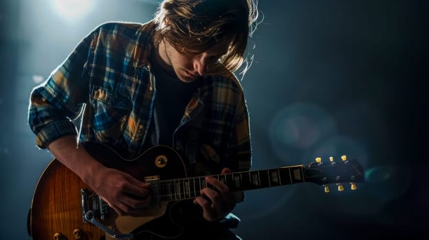 Moody stage lighting highlights a male guitarist deeply focused on playing his electric guitar