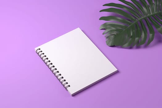Blank spiral notebook with a green leaf on purple background