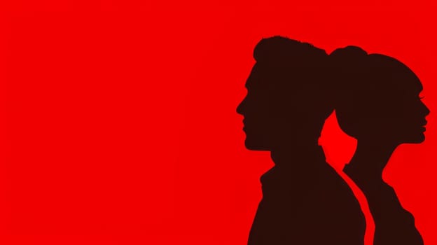 Side view of a male and female silhouette with a vivid red backdrop