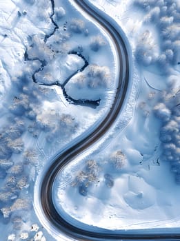 An electric blue pattern of winding road in snow seen from above resembles a circle rim on a vehicle door, creating a beautiful landscape view