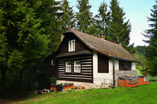 Beautiful old traditional house in the mountains in the Czech Republic. Cottage in nature.