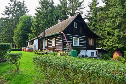 Beautiful old traditional house in the mountains in the Czech Republic. Cottage in nature.