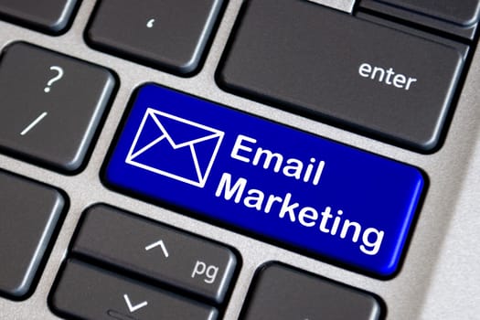 Email marketing text on blue laptop keyboard. Online marketing concept.